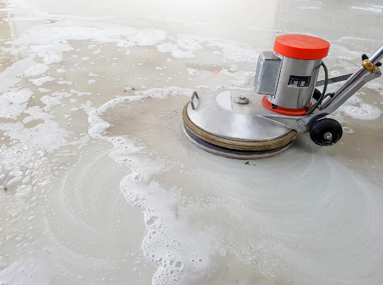 A stone floor being machine polished by Fresher Pressure